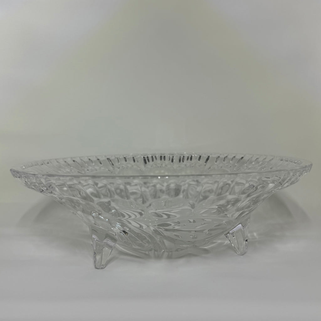 Clear glass bowl with intricate designs on a white background