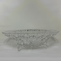 Clear glass bowl with intricate designs on a white background