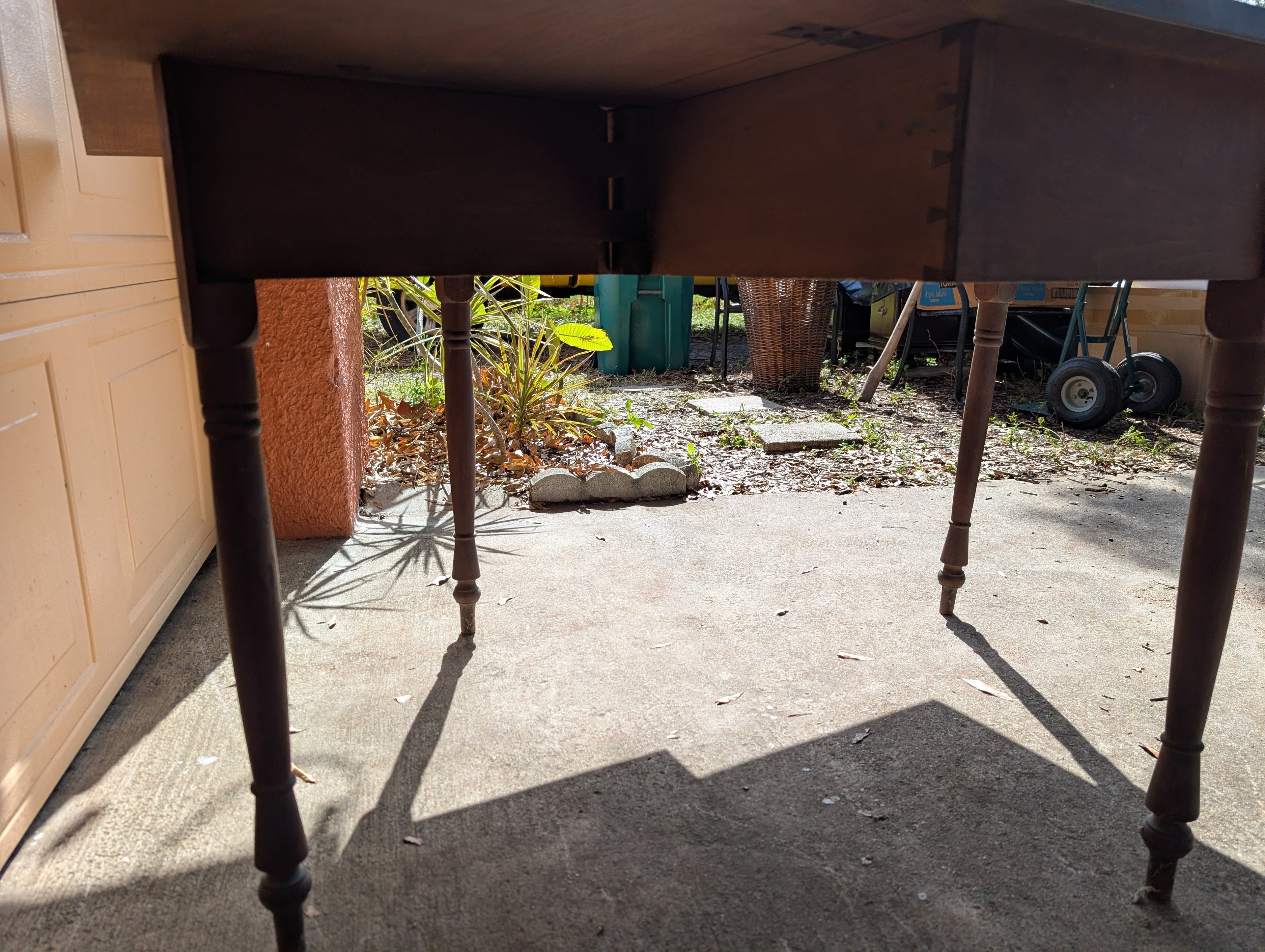 Antique wooden dining table with folding leaves